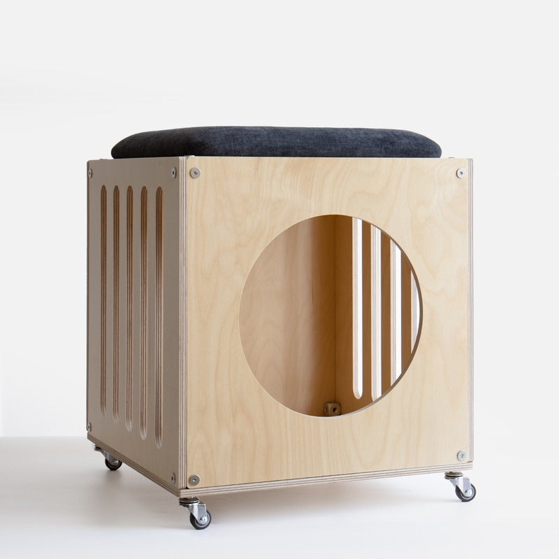 CheerMoe Haven Cat House Stool in a natural wood finish with a dark seat cushion and caster wheels