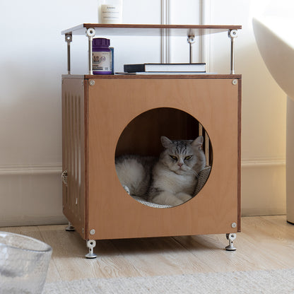 Cat resting inside the walnut-finish CheerMoe Haven Cat House with books on the open shelf