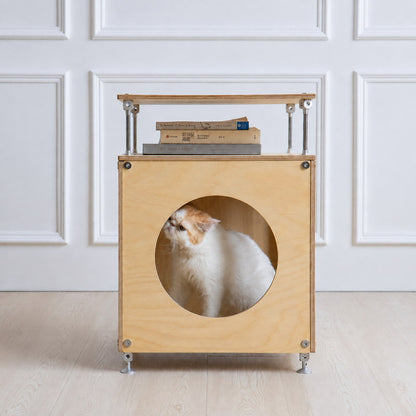 CheerMoe Haven Cat House in natural birch plywood with a white cat resting inside