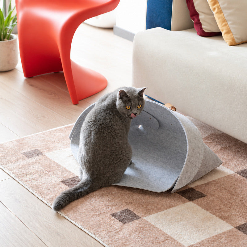 Gray cat beside the foldable gray felt CheerMoe Pica Pet Nest in a modern living room