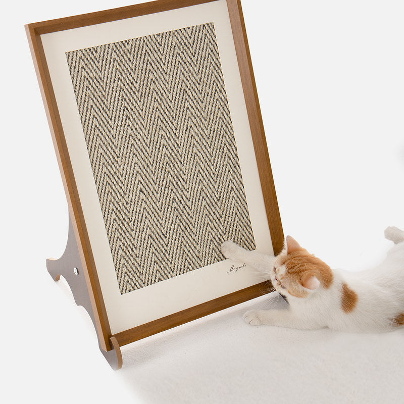 Orange and white cat reaching across the framed vertical scratcher