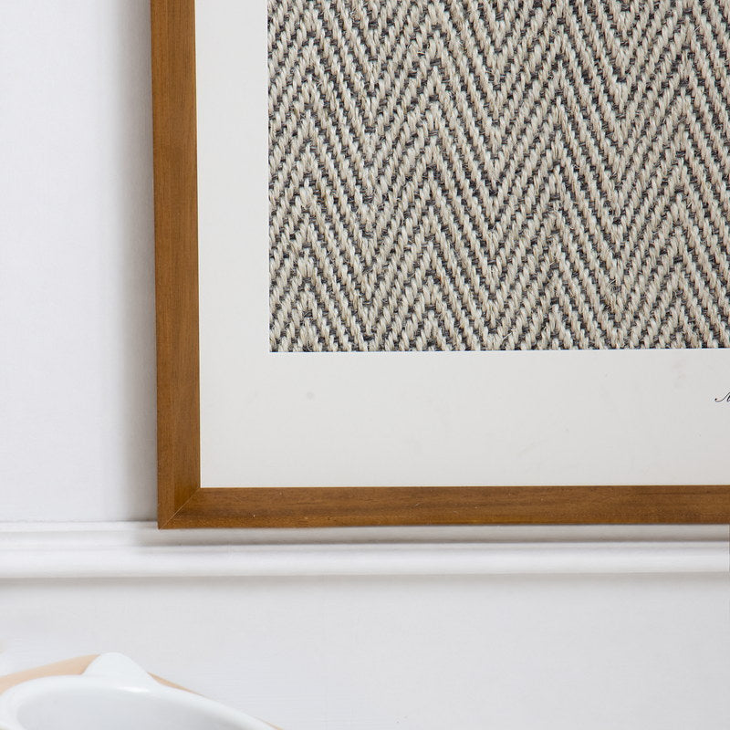 Close-up of the wall-mounted framed sisal scratcher in a home interior